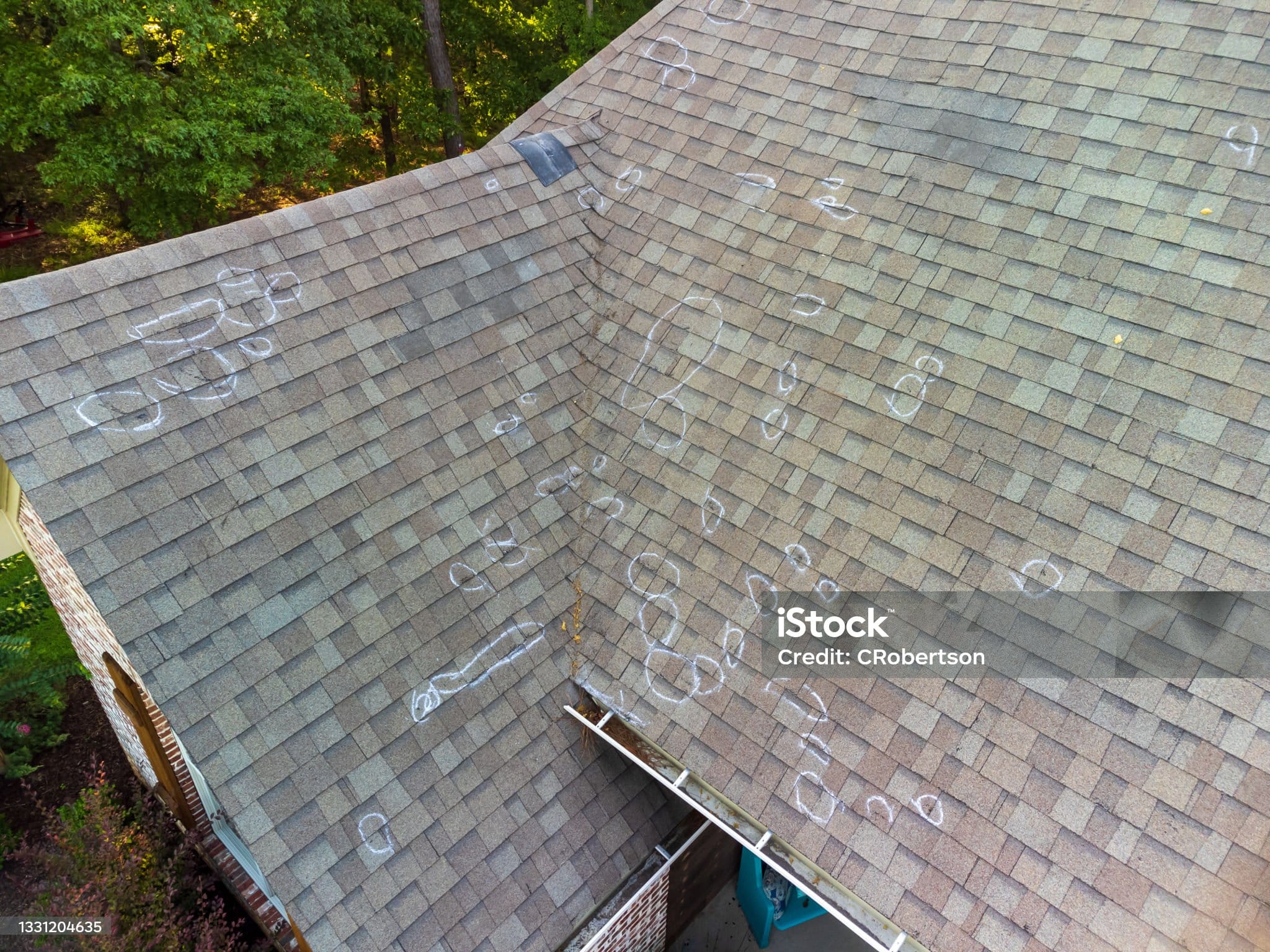 Roo0f with hail damage and chalk markings from inspection