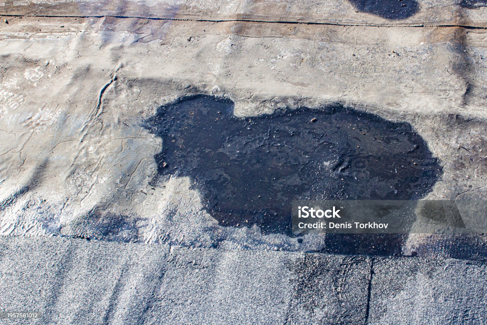storm drain on a bitumen roof and rain puddles on an old unrepaired roof, the problem of leakage of old housing stock