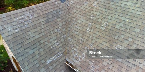 Roo0f with hail damage and chalk markings from inspection