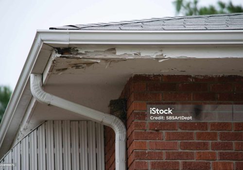 Home exterior in disrepair to roof, gutter, chimney, siding.