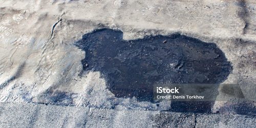 storm drain on a bitumen roof and rain puddles on an old unrepaired roof, the problem of leakage of old housing stock